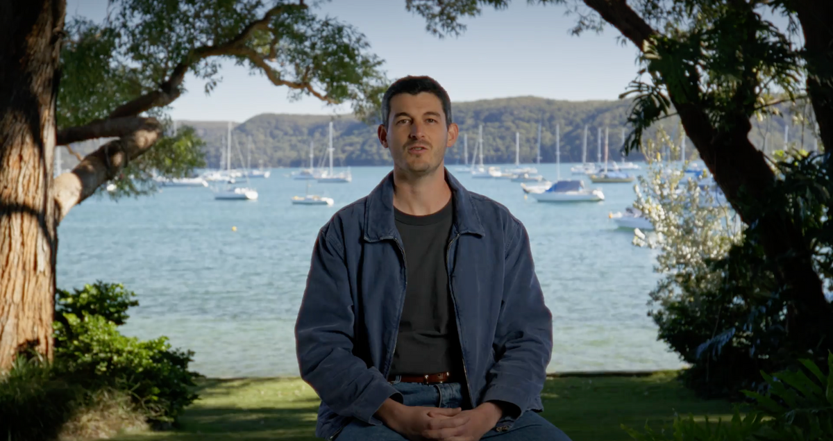 Kindra co-founder Ethan Pearson speaking beside the water