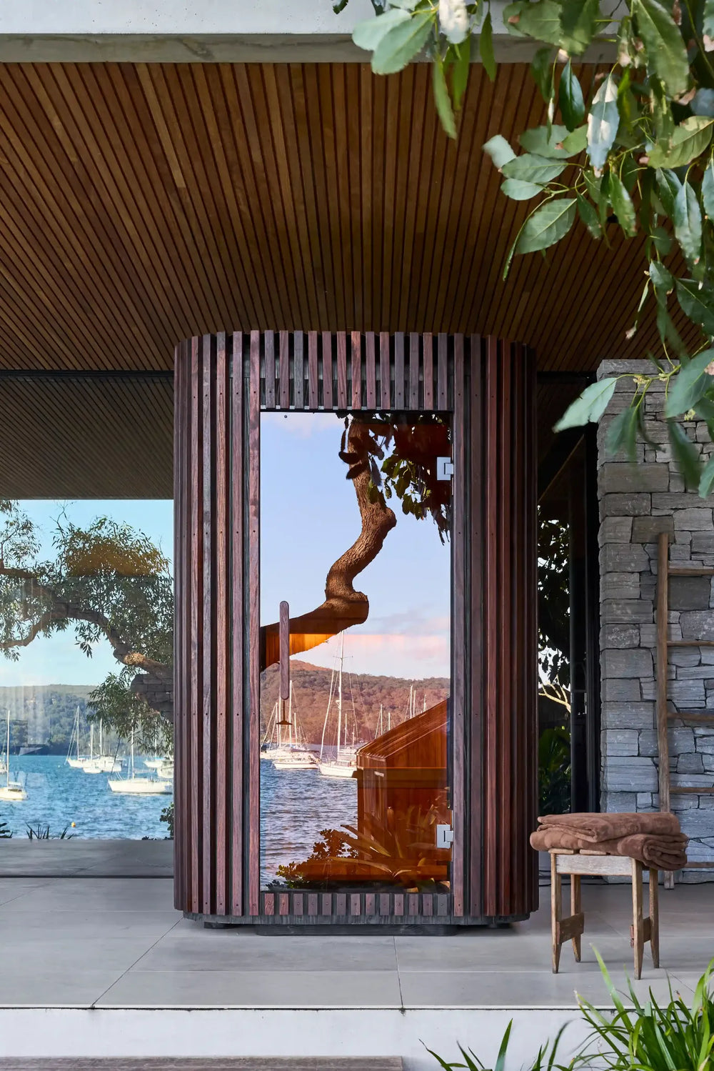 Elata on a covered terrace, with the waterfront reflected in its glass door