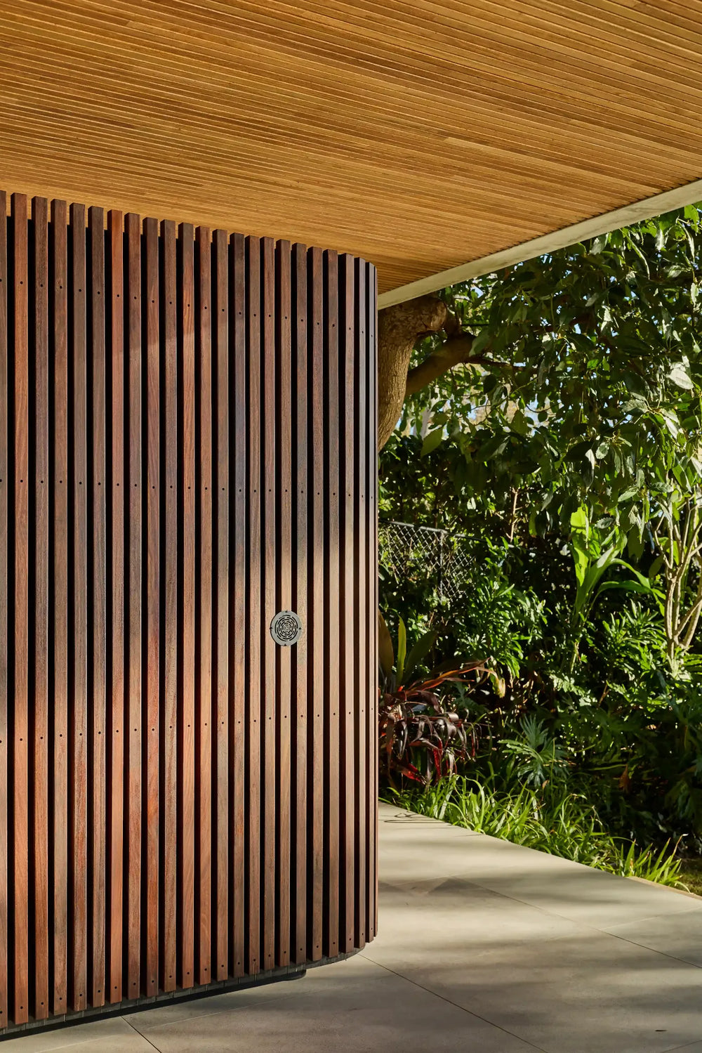 Elata’s curved timber exterior beside the garden
