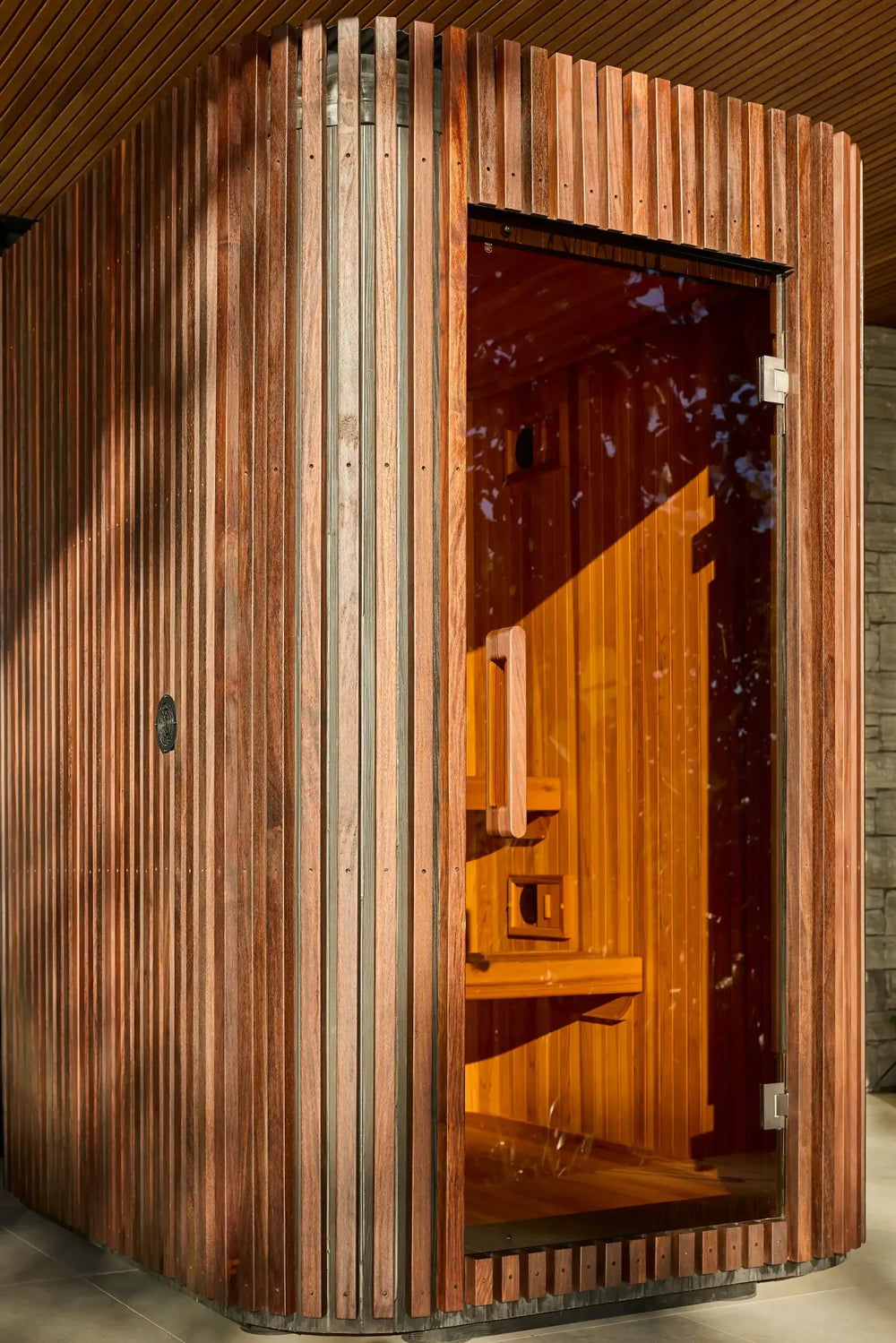 Afternoon sunlight across Elata’s timber exterior and glass door